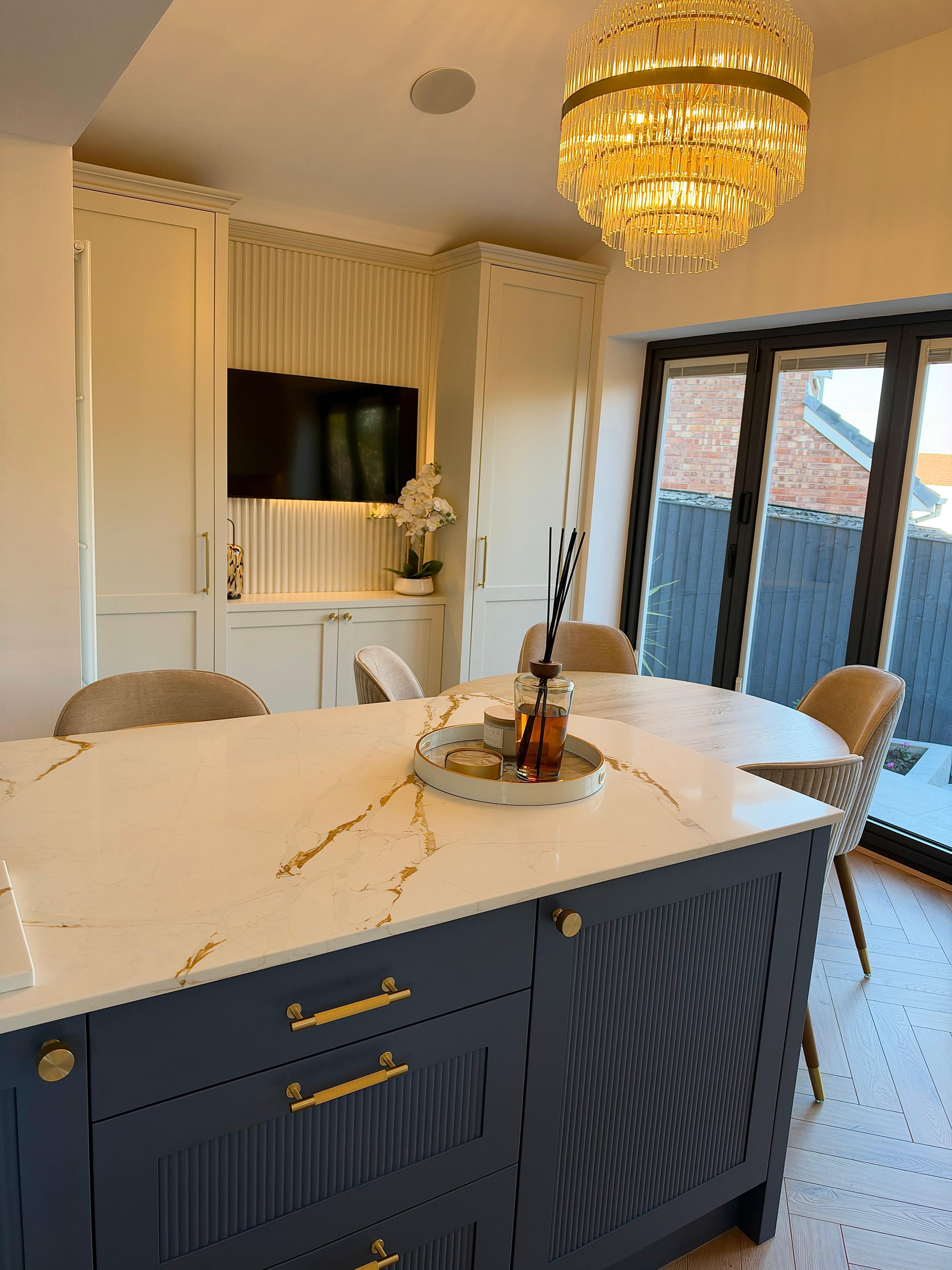 Bespoke kitchen island and dining area with brass details