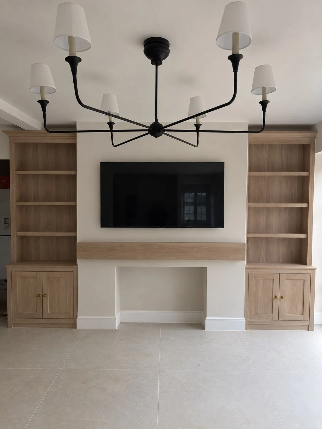 Oak fitted media wall with open shelving and lower cabinets